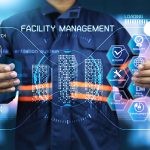Facility management concept with holographic interface showing building systems, maintenance, security, quality, technology, real estate, and environment solutions